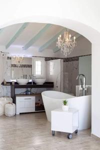 a bathroom with a large tub and two sinks at Casa Roberto Altea in Altea