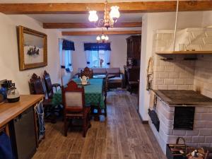 a kitchen and living room with a table and a dining room at Skroblakówka 