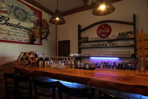 a bar with a large wooden table in a restaurant at Lodge Clubman in Hachimantai