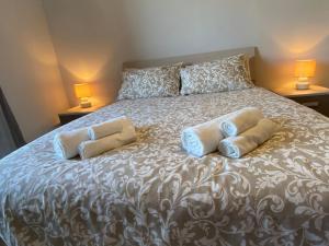 a bedroom with a large bed with two pillows at Elegante Appartamento Tre Amis - Doppio Garage & Free WiFi in Centallo