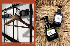 a picture of a bottle of perfume next to a clothes rack at Stay Thought in Suratthani