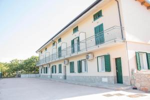a large white building with green shuttered windows at Zio Tonino in Termoli