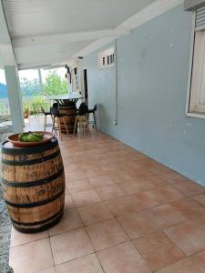 a room with a large barrel sitting on a tile floor at Maison de 4 chambres avec jacuzzi terrasse et wifi a Riviere Pilote a 3 km de la plage in Rivière-Pilote