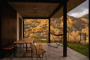 a patio with a table and chairs and a view at Vacation home Khatosi in Oni