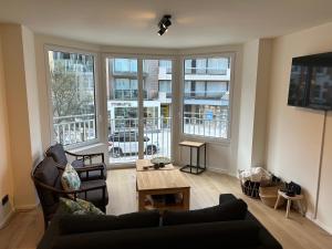 a living room with a couch and a table at Louis-Gabriël in De Panne
