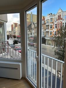 a window with a view of a city street at Louis-Gabriël in De Panne +8 photos