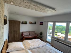 a bedroom with a bed and a large window at SUNRISE mit großer Terrasse und Weitblick in Pirmasens