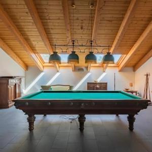 a pool table in a room with a ceiling and lights at Apartment+garage near Novegro Exhibition/Linate in Segrate