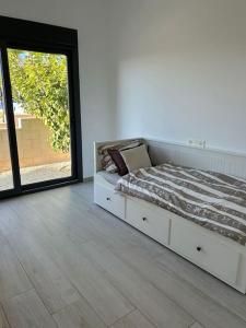 a bedroom with a bed and a large window at Villa Tropical - Alegría Village in Finestrat