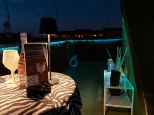 a table with a lamp and a sign on it at G-house in Parma