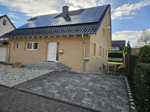 a house with solar panels on the roof at Charmante und stilvolle Wohnung in Alfter