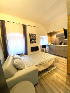 a bedroom with a bed and a couch at K&H Apartman in Jihlava