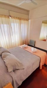 a bedroom with a bed with two towels on it at Departamento en Mendoza in Mendoza