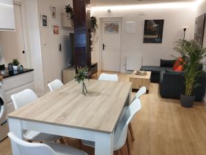 a dining room and living room with a table and chairs at Apartamento La Carola in Bilbao