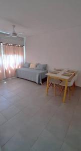 a living room with a bed and a table at Departamento en Mendoza in Mendoza