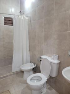 uma casa de banho com um WC e um lavatório em Hermosa Casita paso patria III em Paso de la Patria