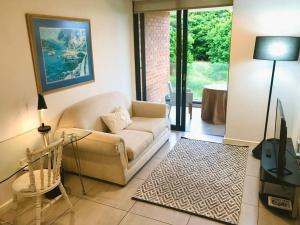 a living room with a couch and a table at 1 bedroom apartment in Sibaya in Sibaya