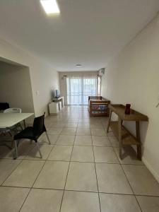 an empty living room with a table and chairs at Elegante departamento en Mendoza in Mendoza