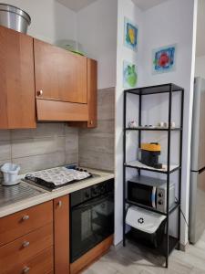 a small kitchen with a stove and a shelf at Loftiense Roma in Rome
