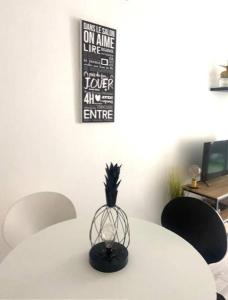 a white table with a pineapple on top of it at Bottero-Joli Studio avec terrasse 5 mins de la mer in Nice