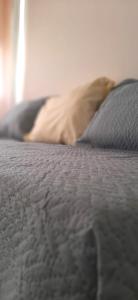 a close up of a bed with a pillow at Departamento en Mendoza in Mendoza