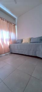 a bedroom with a bed in a room with a tile floor at Departamento en Mendoza in Mendoza