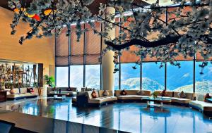 a lobby with couches and tables and large windows at Amazing Hotel Sapa in Sa Pa
