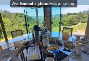 a table with food on it with a view at Refúgio nascer das águas in Gravatal