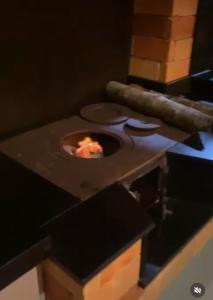 a kitchen with a pizza oven on a table at Refúgio nascer das águas in Gravatal