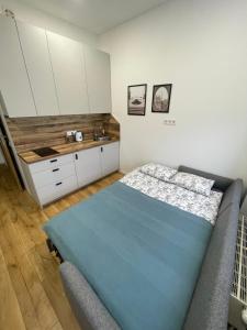 a bedroom with a bed and a sink at Airport Apartment 25 Self Check-In Fee Parking in Vilnius