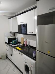 a kitchen with a stainless steel refrigerator and a dishwasher at Yola hime in Istanbul