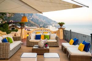 a patio with couches and a view of the ocean at Casa Mercè Positano in Positano