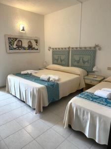Postel nebo postele na pokoji v ubytování Hotel Canne al Vento
