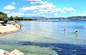 a group of people in the water at a beach at Appartamento Aris in Monfalcone