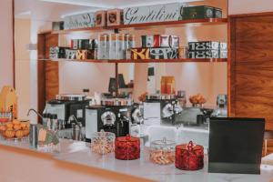 a coffee shop with coffee machines on a counter at Albergo Delle Regioni, Barberini - Fontana di Trevi in Rome +285 photos