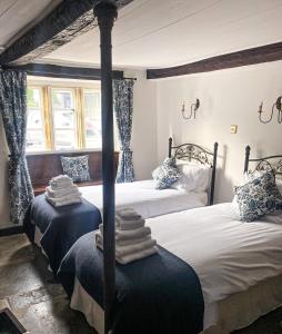 a bedroom with two beds with towels on them at The New Inn in Yeovil