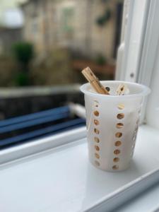 a cup with chopsticks in it sitting on a window sill at LAR DE SEFA in Redondela