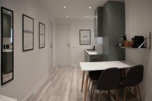 a kitchen with a white table and chairs at CASA BIA in Bergamo +7 photos