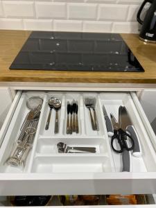 a drawer filled with utensils in a kitchen at LAR DE SEFA in Redondela