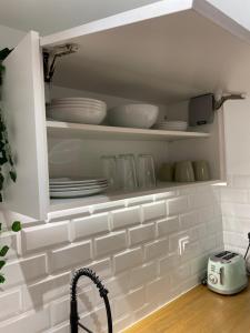 a kitchen cabinet with plates and dishes in it at LAR DE SEFA in Redondela
