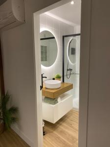 a bathroom with a sink and a mirror at LAR DE SEFA in Redondela +27 photos