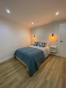 a bedroom with a bed with two pillows on it at LAR DE SEFA in Redondela