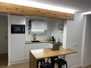 a kitchen with a table with a laptop on it at LAR DE SEFA in Redondela