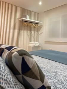 a bedroom with a bed with a pillow on it at LAR DE SEFA in Redondela