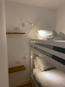 a bedroom with two bunk beds with lights on them at LAR DE SEFA in Redondela