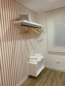 a room with a closet with towels and a shelf at LAR DE SEFA in Redondela