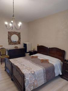 a bedroom with a large bed and a chandelier at La Finestra sul Velino, uno splendore da vivere in Rieti