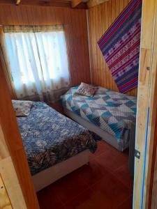 A bed or beds in a room at Cabañas EL LUSA
