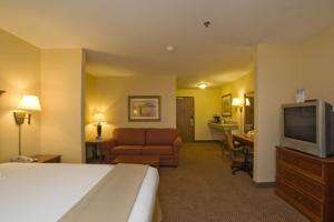 a hotel room with a bed and a flat screen tv at Holiday Inn Express & Suites - Laredo-Event Center Area, an IHG Hotel in Laredo