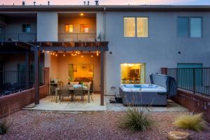 a patio with a hot tub in front of a house at Savannah's Zion Retreat-NEW PRIVATE HOT TUB in Hurricane